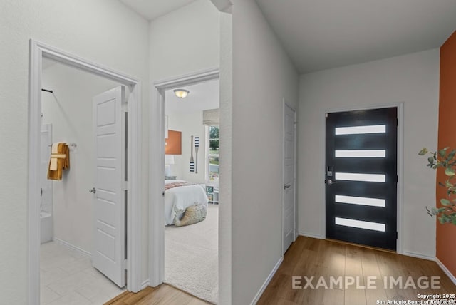 entrance foyer featuring baseboards and light wood-style flooring