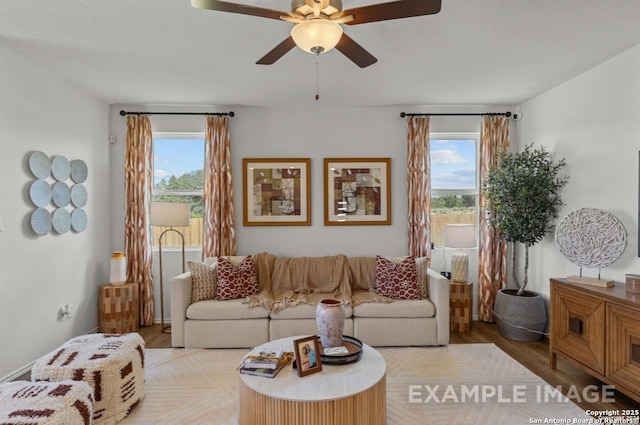 living area featuring ceiling fan and wood finished floors