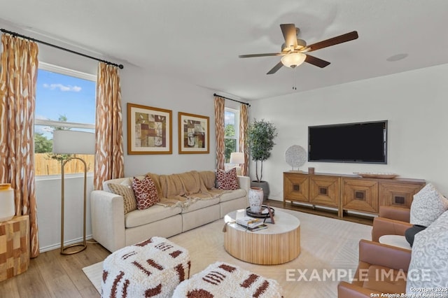 living room featuring ceiling fan and wood finished floors