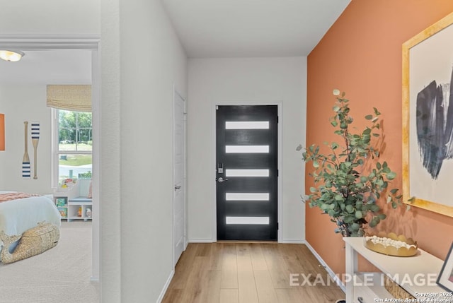 entryway featuring light wood-style floors and baseboards