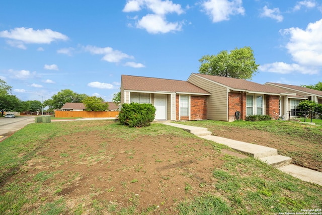 single story home with brick siding and fence