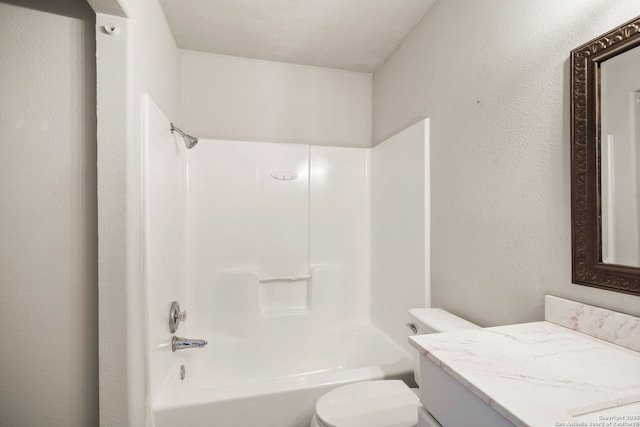 full bathroom with vanity, bathtub / shower combination, and toilet