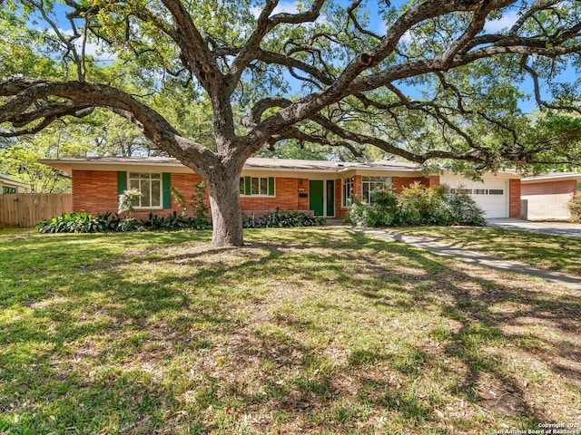 single story home with fence, a front lawn, brick siding, a garage, and concrete driveway