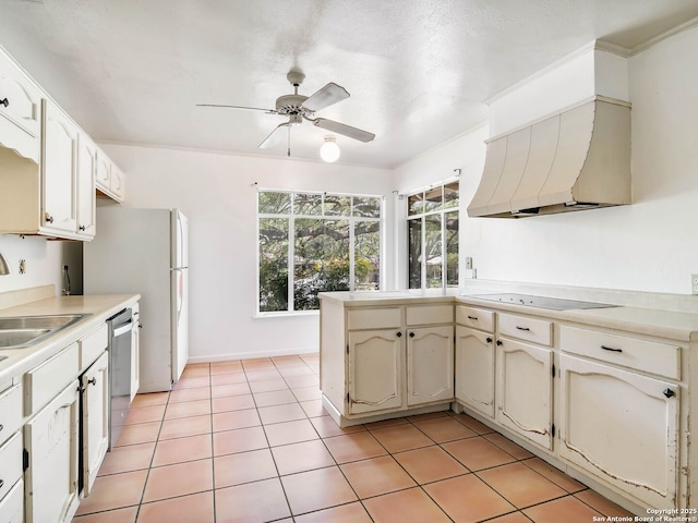 kitchen with ceiling fan, a sink, dishwasher, black electric cooktop, and custom range hood