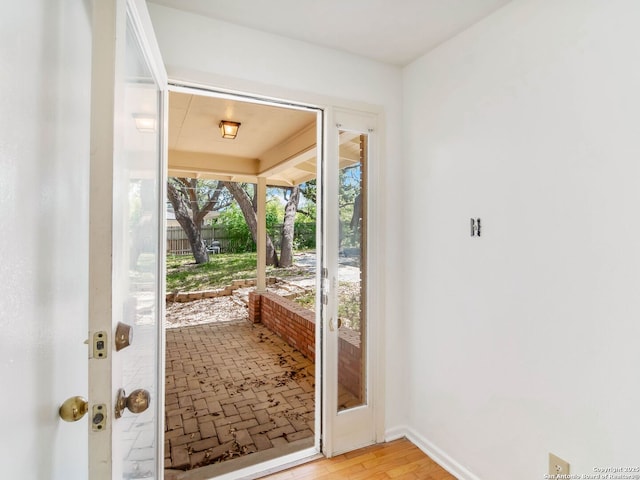 doorway featuring baseboards