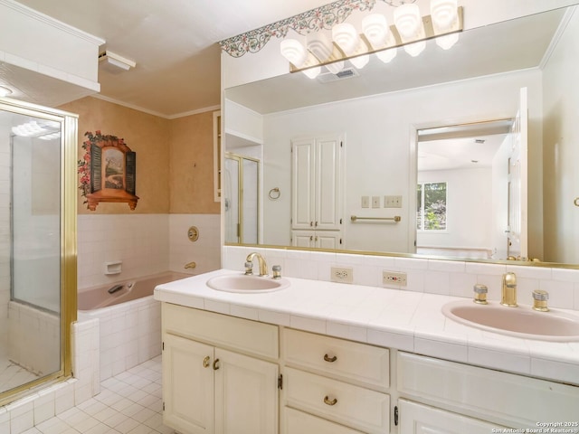 bathroom with a shower stall, a sink, and tile patterned flooring