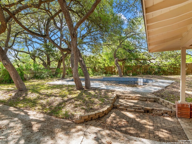 view of yard with a patio, a swimming pool, and a fenced backyard