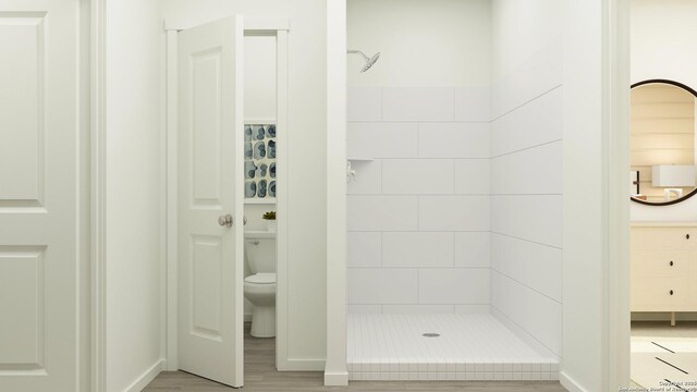 506 Kayden Ct, Marion, TX 78124 - full bathroom featuring toilet, baseboards, a shower stall, and wood finished floors
