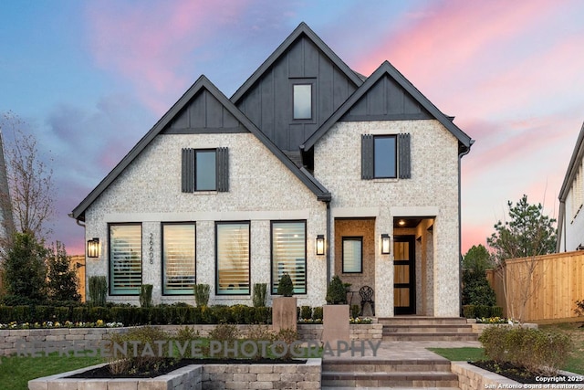 view of front of property with board and batten siding and fence