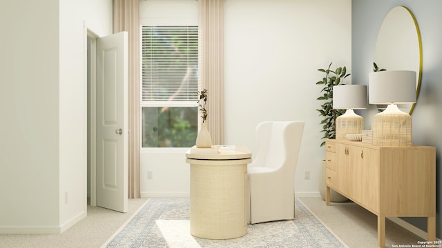 sitting room with baseboards, plenty of natural light, and light carpet