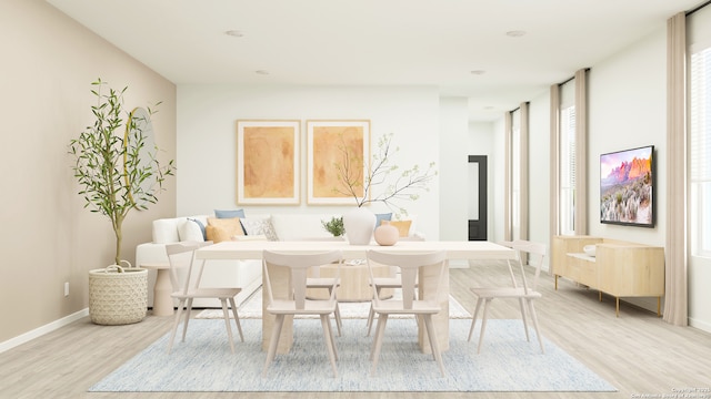 living area with baseboards and light wood-style flooring