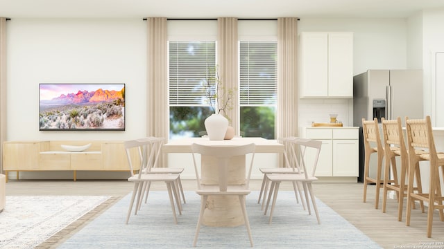 living area with a wealth of natural light and light wood-style flooring