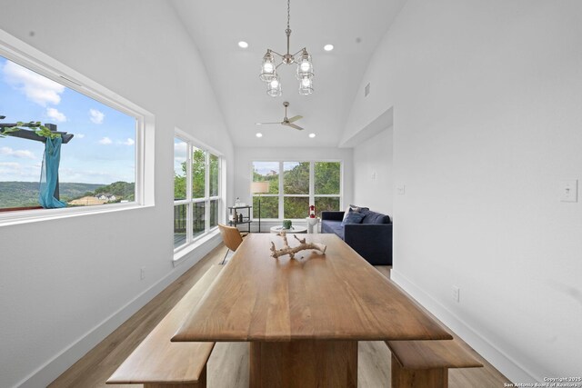 1880 Trail Pass Dr, Canyon Lake, TX 78133 - dining space featuring high vaulted ceiling, ceiling fan with notable chandelier, recessed lighting, baseboards, and wood finished floors