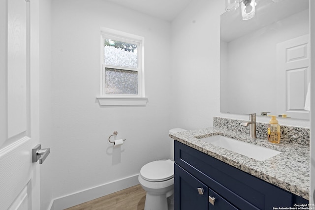 1880 Trail Pass Dr, Canyon Lake, TX 78133 - half bathroom featuring baseboards, wood finished floors, toilet, and vanity