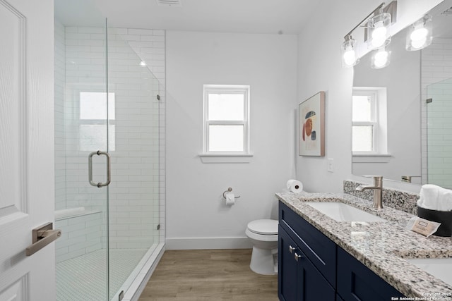 1880 Trail Pass Dr, Canyon Lake, TX 78133 - full bathroom with a sink, toilet, double vanity, wood finished floors, and a stall shower