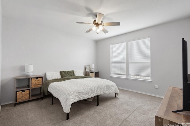 carpeted bedroom with a ceiling fan and baseboards
