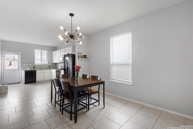 dining area featuring light tile patterned flooring, baseboards, and an inviting chandelier