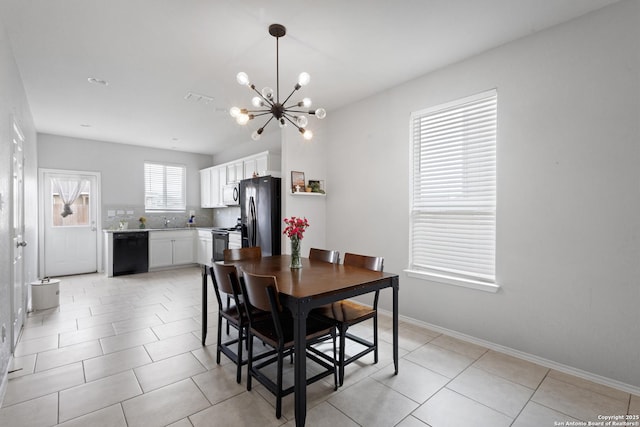 dining space with light tile patterned flooring, baseboards, a notable chandelier, and visible vents