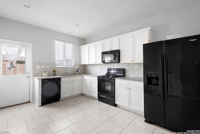 kitchen featuring a healthy amount of sunlight, backsplash, and black appliances