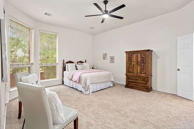 carpeted bedroom with baseboards, visible vents, and ceiling fan