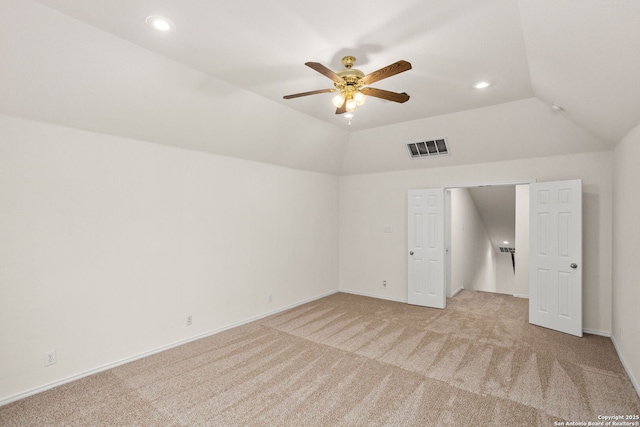 unfurnished bedroom featuring visible vents, recessed lighting, vaulted ceiling, and light carpet