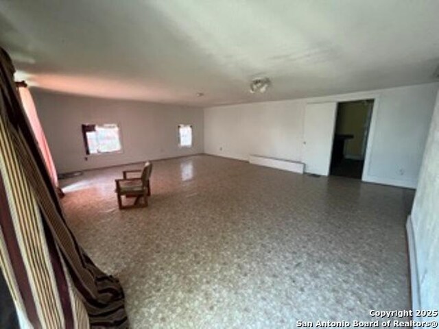 empty room featuring a baseboard heating unit