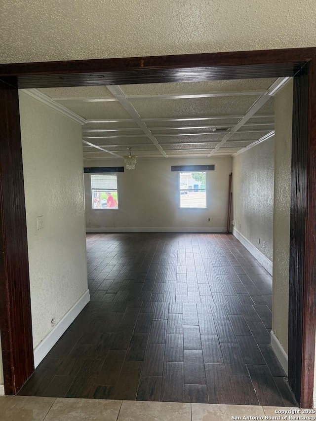 1074 Honeytree St, San Antonio, TX 78245 - unfurnished room with a textured wall, baseboards, dark wood-style floors, and crown molding