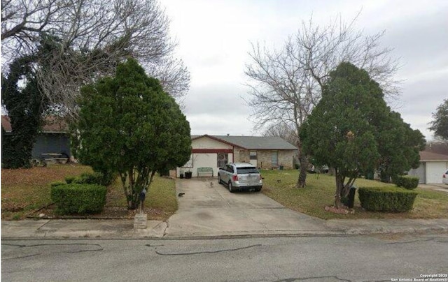 1074 Honeytree St, San Antonio, TX 78245 - view of front facade featuring concrete driveway and a front lawn