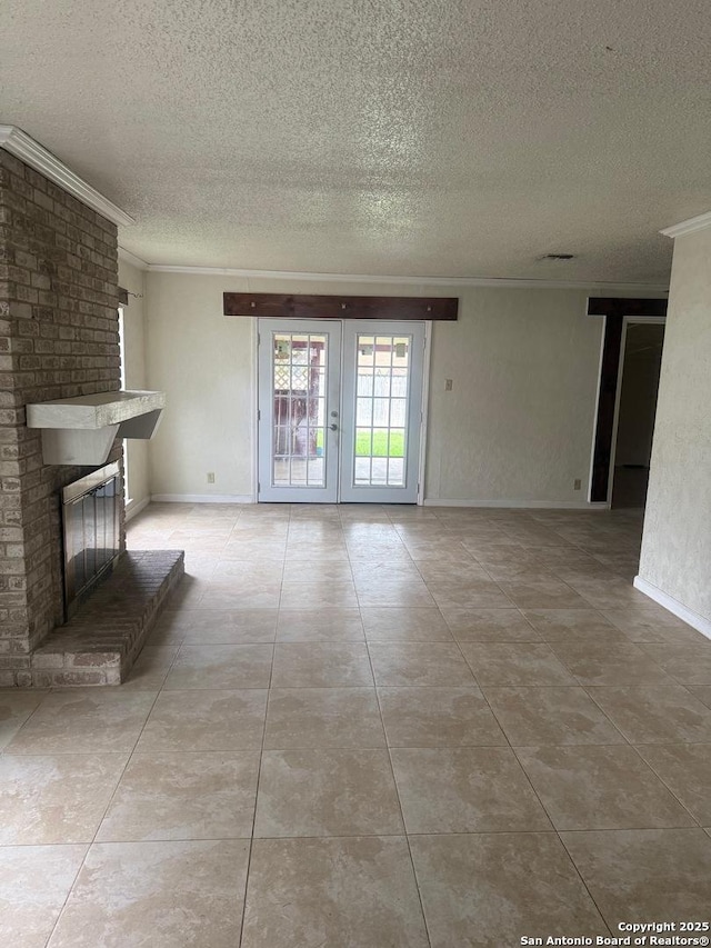 1074 Honeytree St, San Antonio, TX 78245 - unfurnished living room with ornamental molding, a fireplace, a textured ceiling, tile patterned floors, and french doors