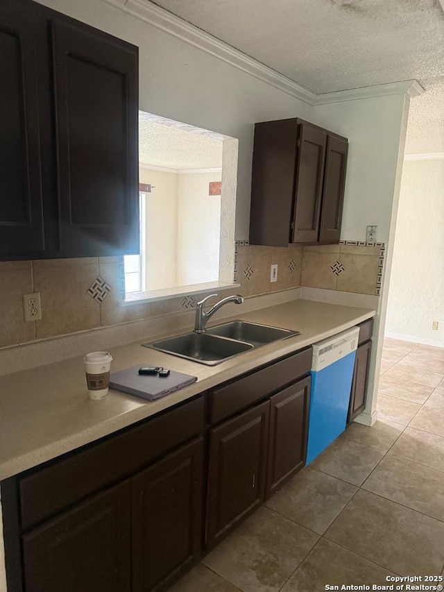 1074 Honeytree St, San Antonio, TX 78245 - kitchen with crown molding, dishwashing machine, a textured ceiling, a sink, and backsplash