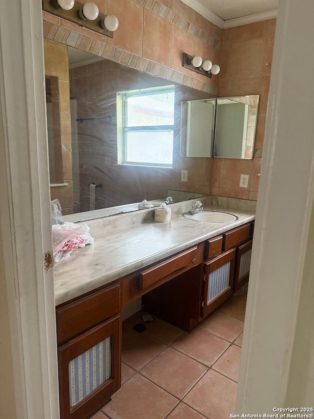 1074 Honeytree St, San Antonio, TX 78245 - full bathroom with vanity, tile patterned flooring, ornamental molding, and tiled shower