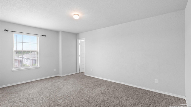 7350 Braes Cor, San Antonio, TX 78244 - spare room with carpet, baseboards, and a textured ceiling