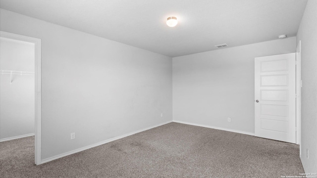 7350 Braes Cor, San Antonio, TX 78244 - unfurnished bedroom featuring carpet floors, a closet, a spacious closet, and baseboards