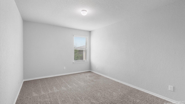 7350 Braes Cor, San Antonio, TX 78244 - spare room featuring carpet, baseboards, and a textured ceiling