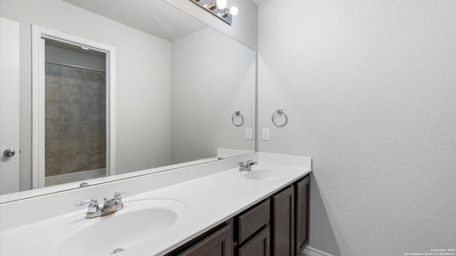 7350 Braes Cor, San Antonio, TX 78244 - full bathroom with double vanity and a textured wall