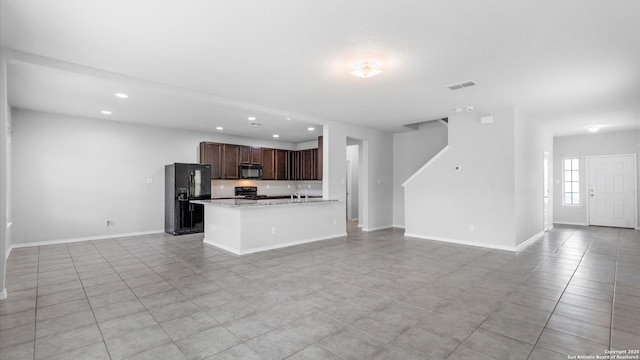 7350 Braes Cor, San Antonio, TX 78244 - kitchen with black appliances, open floor plan, recessed lighting, dark brown cabinetry, and light tile patterned floors