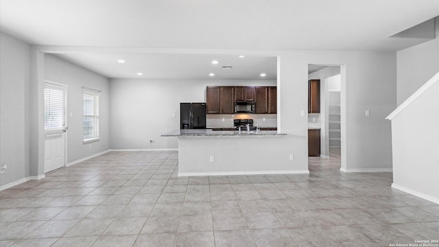 7350 Braes Cor, San Antonio, TX 78244 - kitchen with black appliances, recessed lighting, backsplash, light tile patterned floors, and dark brown cabinets