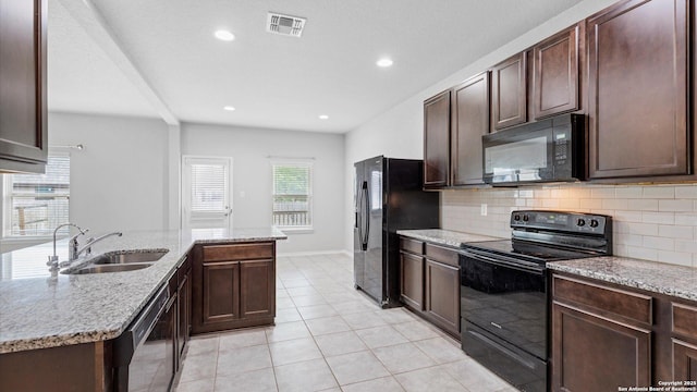7350 Braes Cor, San Antonio, TX 78244 - kitchen with black appliances, a sink, decorative backsplash, light tile patterned floors, and dark brown cabinets