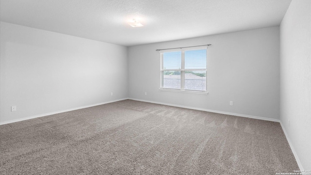 7350 Braes Cor, San Antonio, TX 78244 - carpeted spare room featuring baseboards and a textured ceiling
