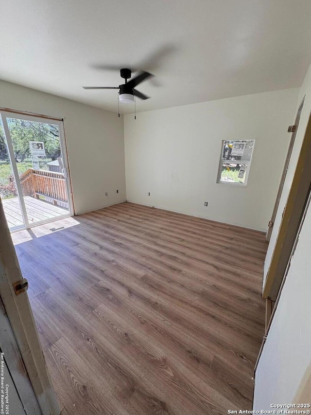 empty room featuring ceiling fan and wood finished floors
