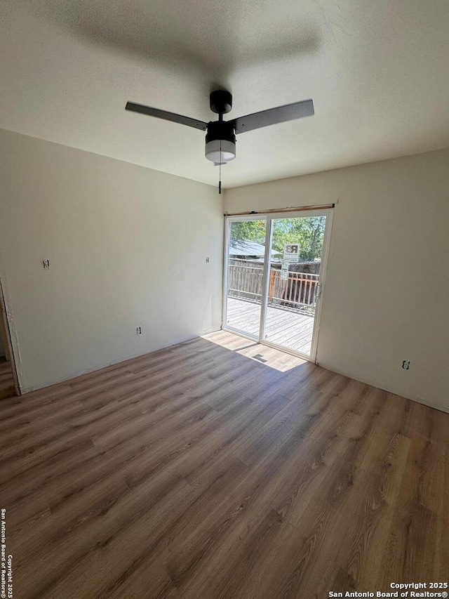 spare room with ceiling fan and wood finished floors