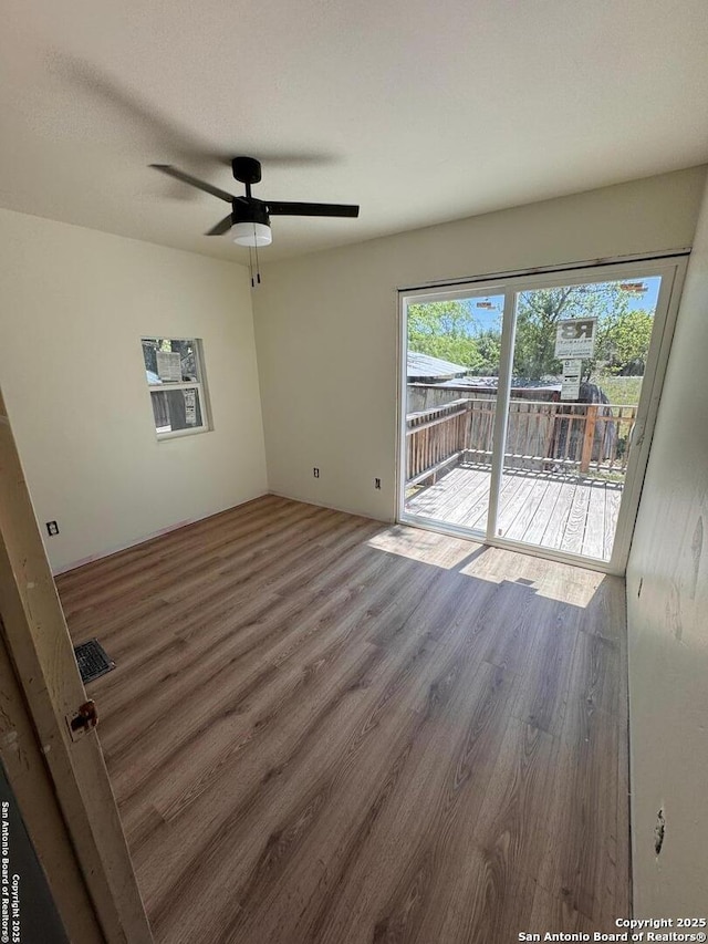 unfurnished room with ceiling fan and wood finished floors