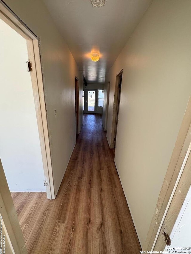 corridor featuring wood finished floors