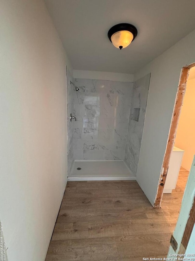 bathroom featuring a shower and wood finished floors