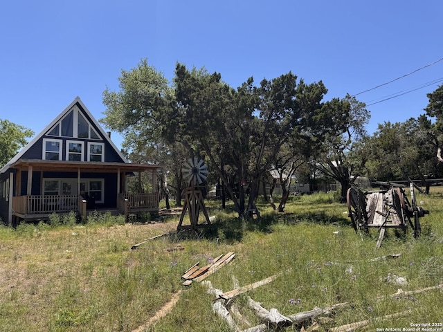 view of yard with covered porch