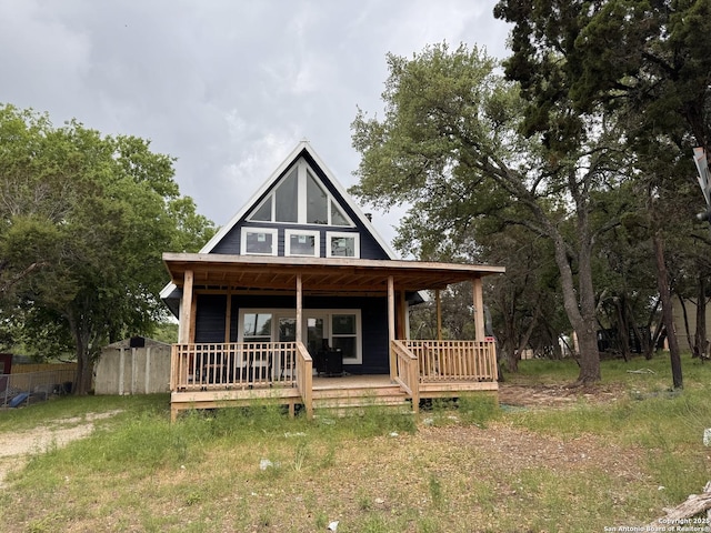 view of front facade featuring fence and a porch