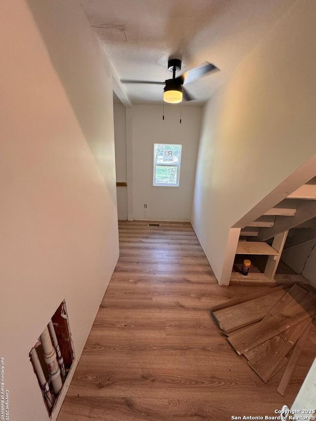 interior space featuring ceiling fan, wood finished floors, and visible vents