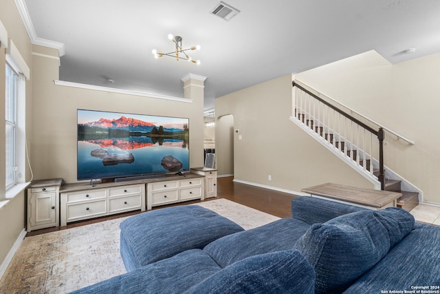 living area with visible vents, ornamental molding, stairs, an inviting chandelier, and baseboards