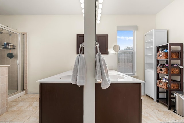 full bath featuring a stall shower, tile patterned flooring, and vanity