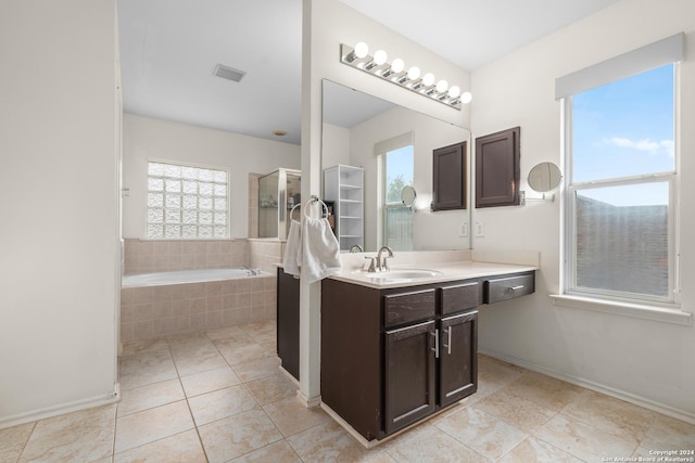 full bath featuring a shower with shower door, vanity, tile patterned floors, visible vents, and a bath
